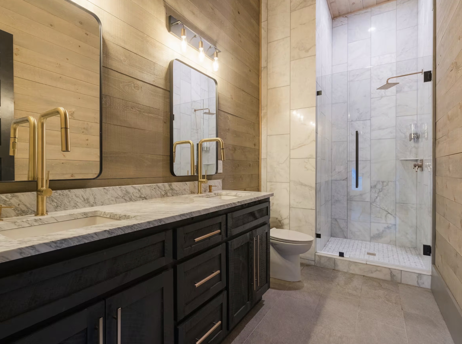 Bathroom with double marble vanity and brass fixtures