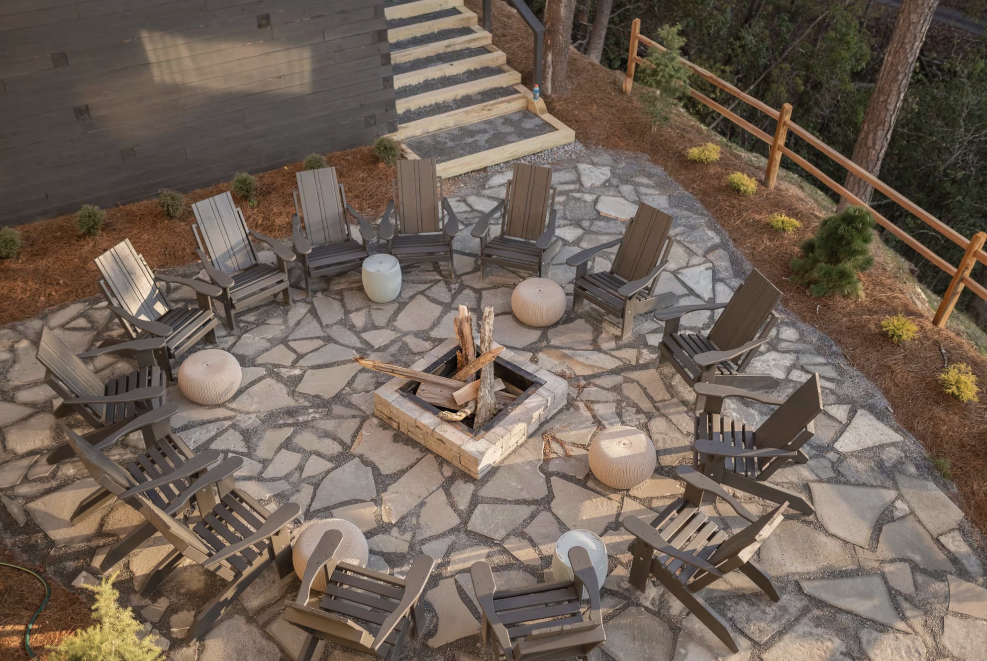 Stone fire circle surrounded by chairs in the woods