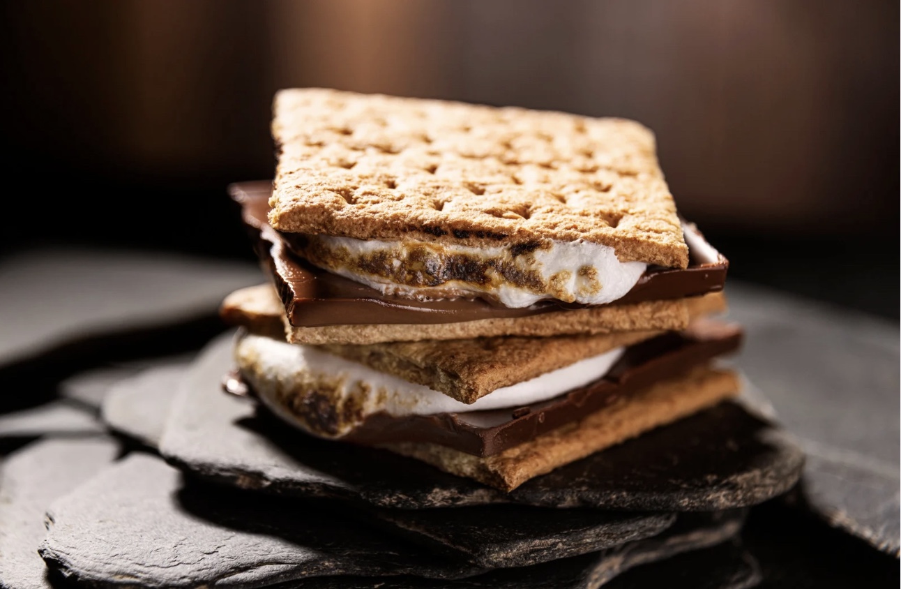 A stacked s'more with melted chocolate and toasted marshmallow